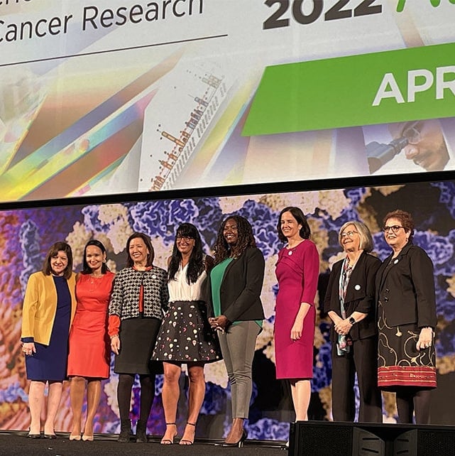 women onstage at cancer research event 2022