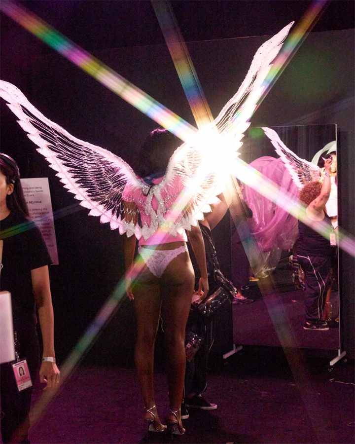 Angel Reese wears a pair of lace panties and wings that shine brightly backstage at the 2025 Victoria’s Secret Fashion Show.