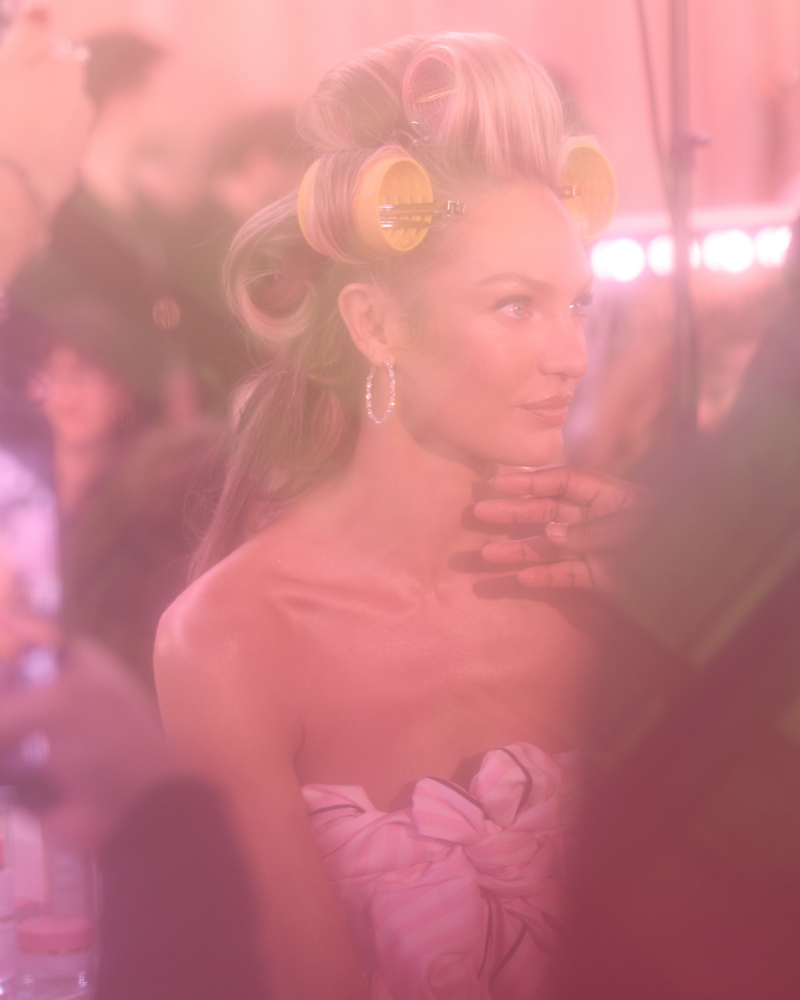 Candice Swanepoel gets her hair curled and makeup applied backstage at the 2025 Victoria’s Secret Fashion Show.